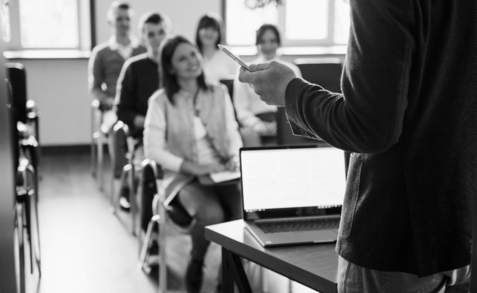 Collaborative workspace showing team members reviewing test documentation and discussing testing strategies